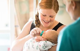 Mother holding newborn baby.