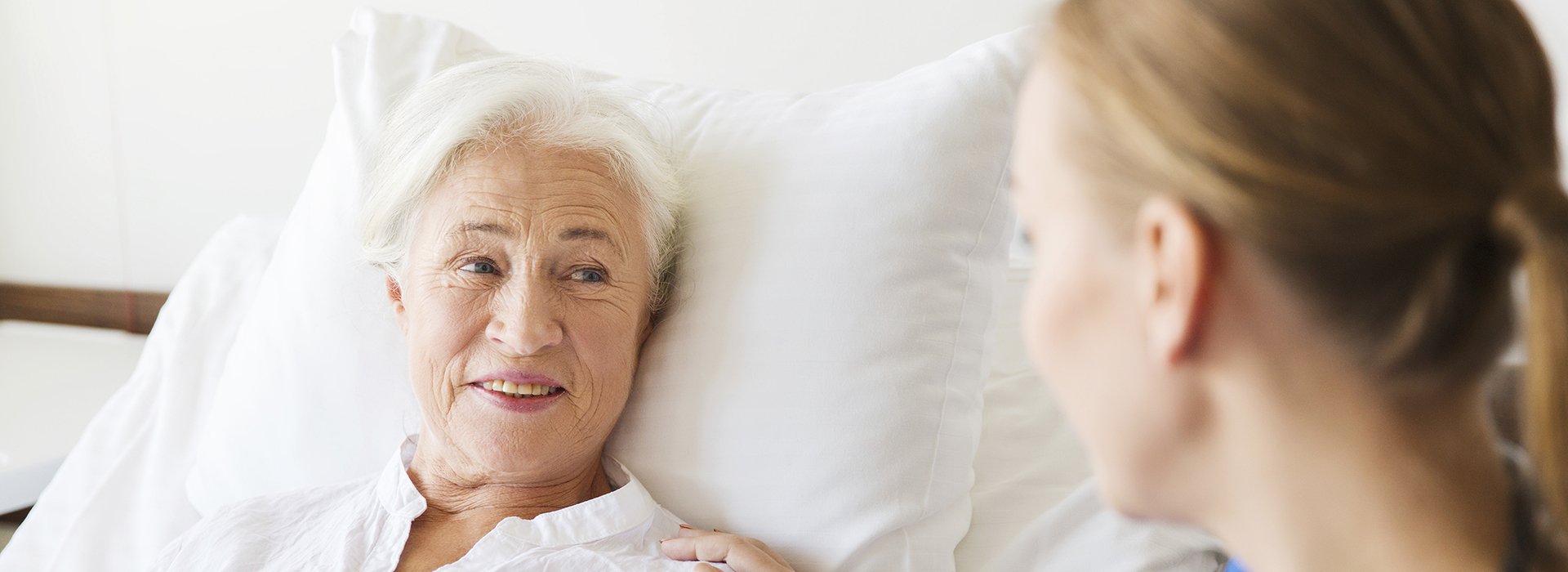 Mature woman in hospital bed.