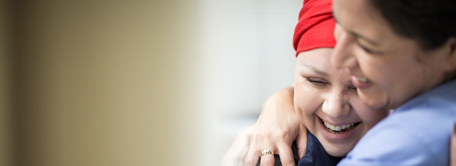 Cancer patient hugging nurse.