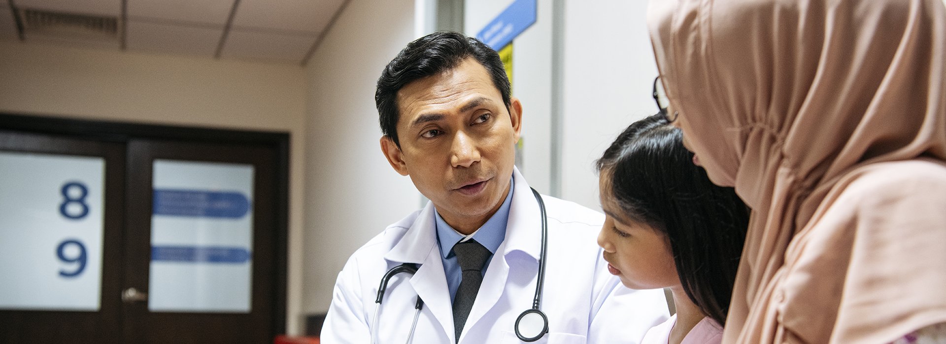 Doctor talking to woman and child.