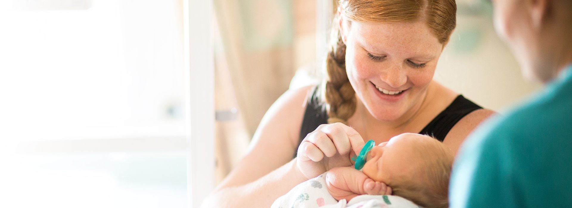 Mother holding a newborn infant.