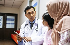 Doctor talking to mother and daughter.