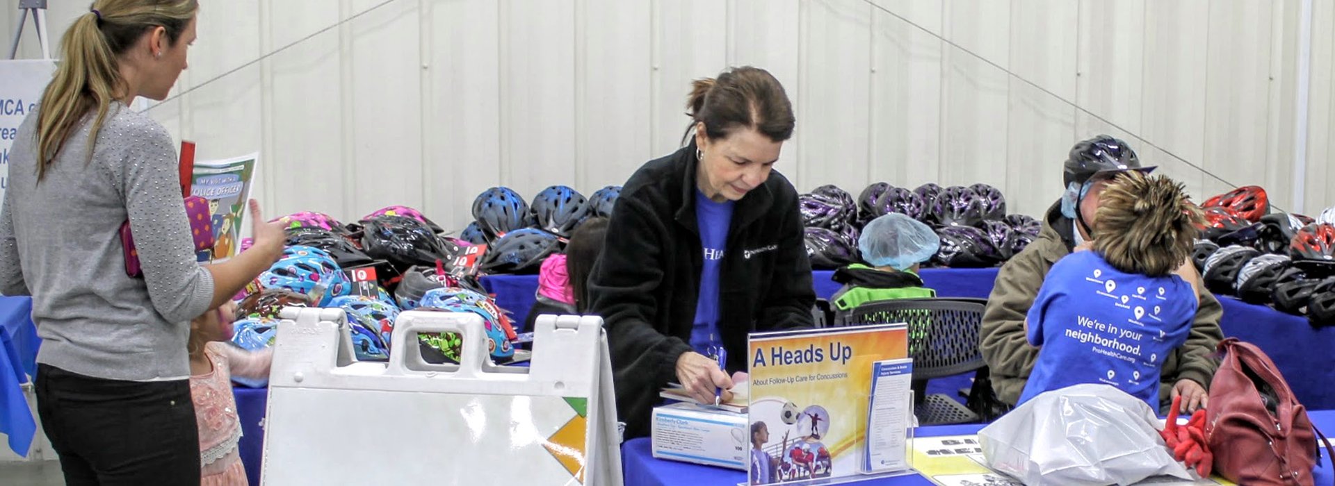 Selling bike helmets at community event.