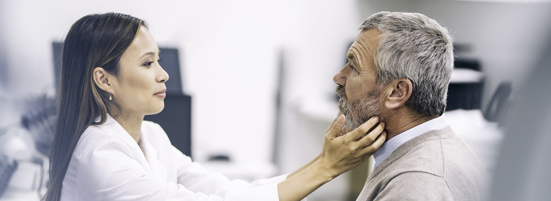 Doctor performing neck exam.