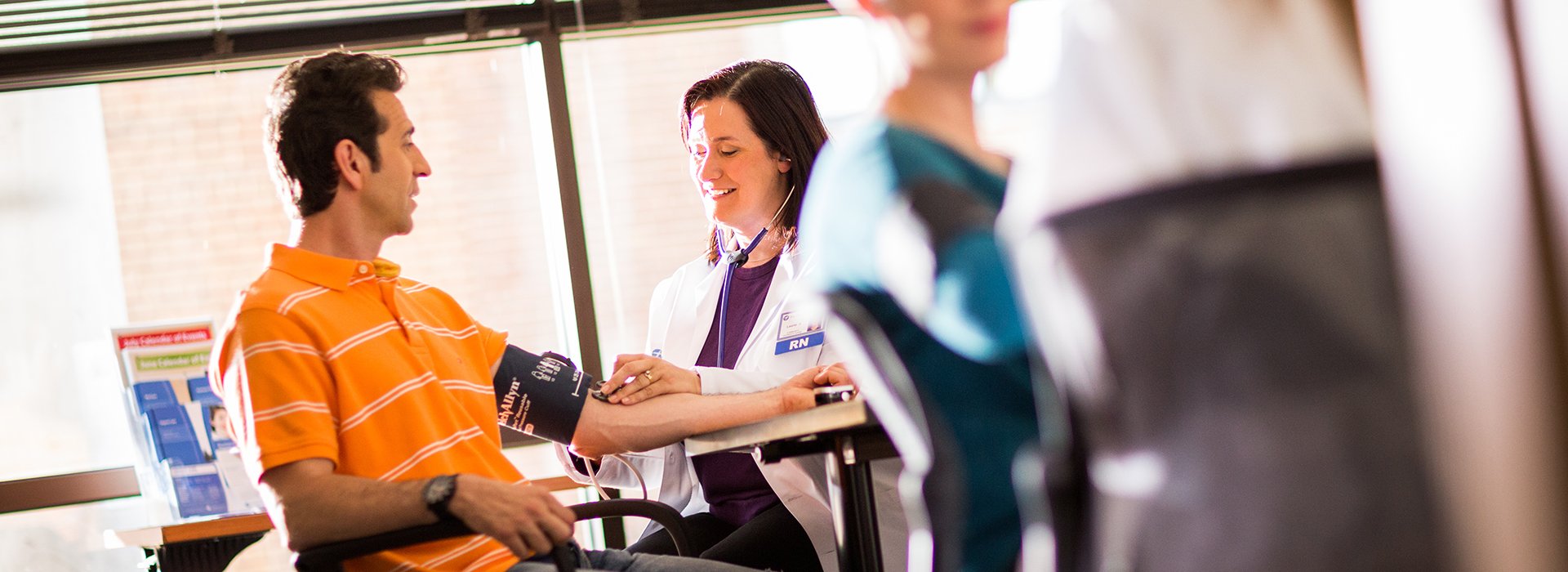 Nurse taking blood pressure.