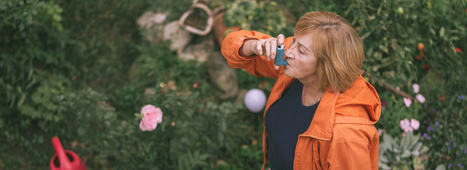 Woman using a rescue inhaler.