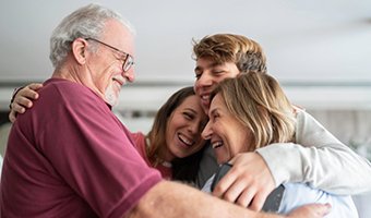 Family hugging each other.